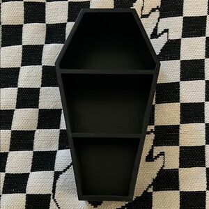 Sourpuss coffin shelf